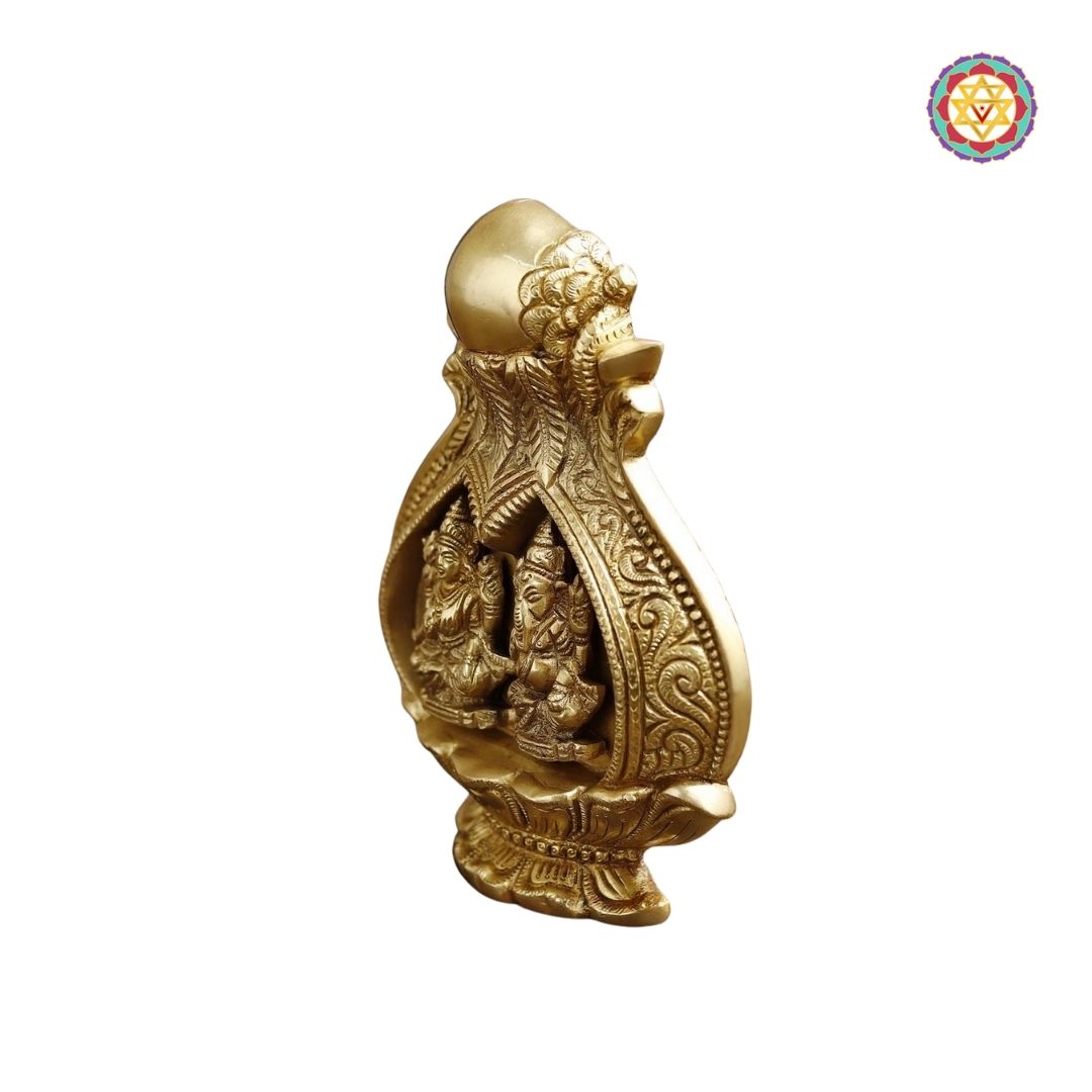 side view of brass kalash showing engraved Lakshmi and Ganesh motifs with ornate detailing