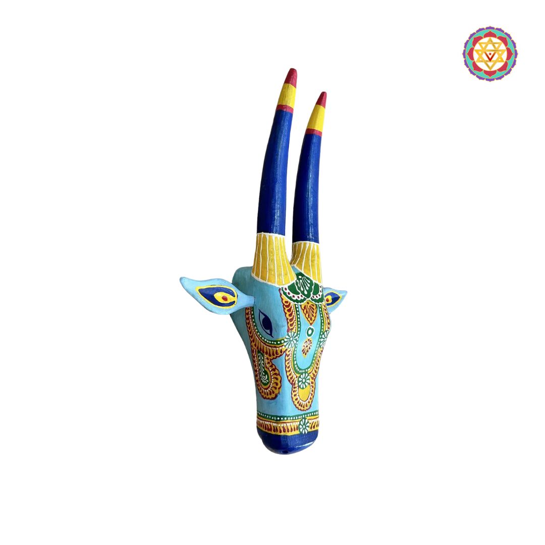 side profile of blue and yellow cow head highlighting carved wood craftsmanship