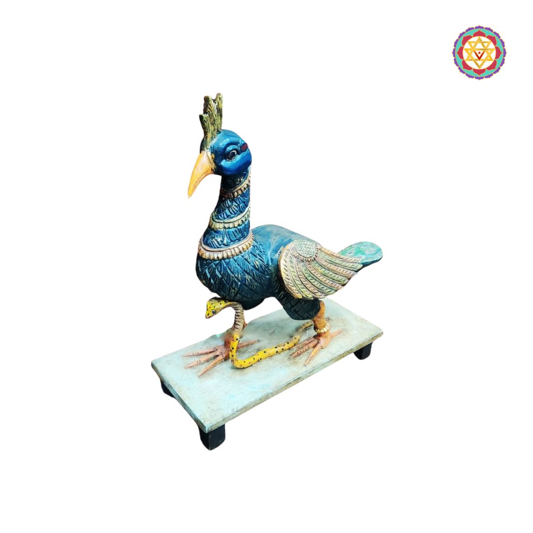 side view of decorative peacock statue with carved feathers