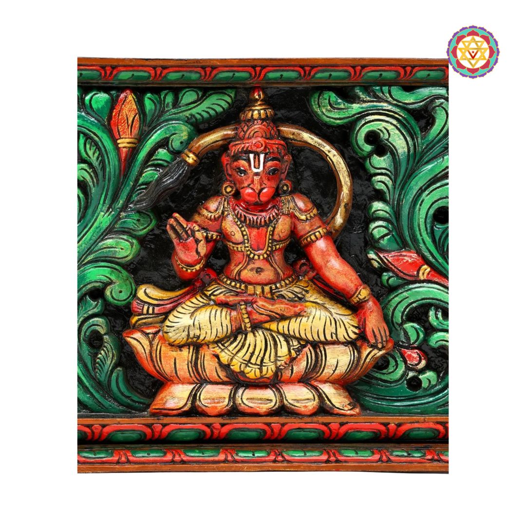 Colorful sculpture of a seated figure with intricate green and red background