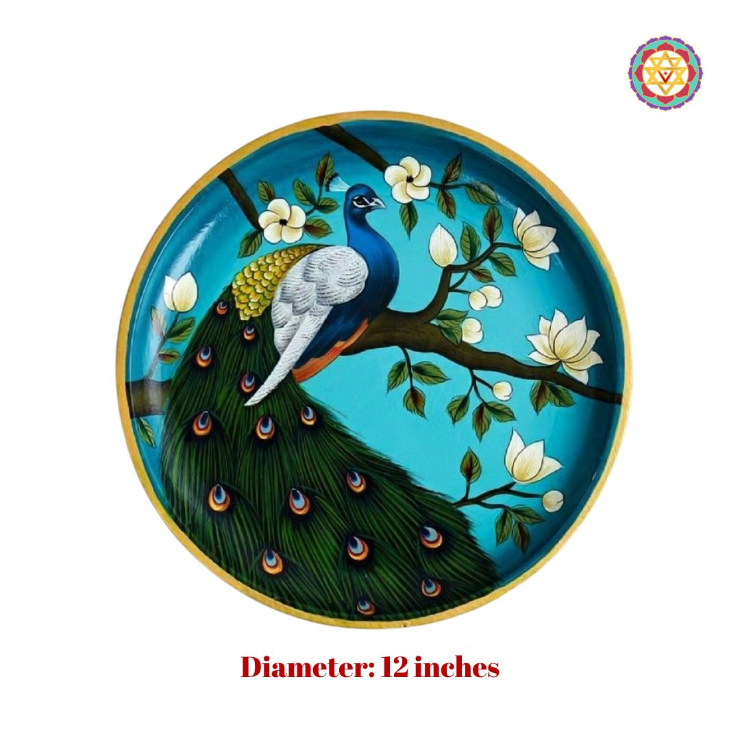 Close-up of handpainted peacock wall plate on teal blue backdrop, pichwai-inspired.