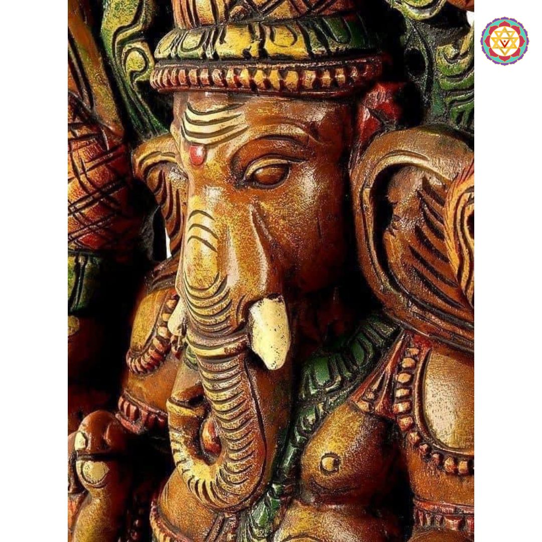Angled view of Ganesha on lotus base — antique brown finish, handcrafted wooden temple idol