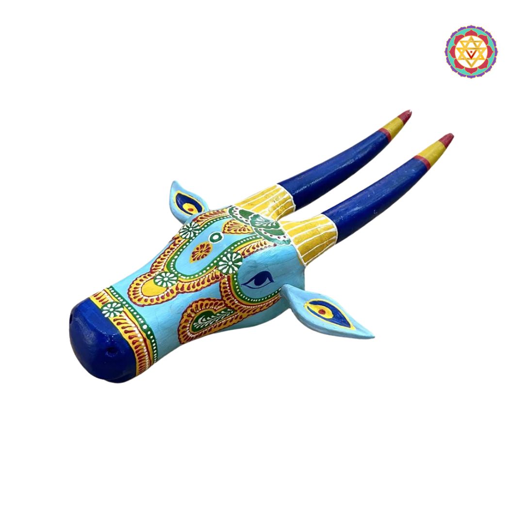 close-up of hand-painted blue and yellow cow head showing intricate details and shading