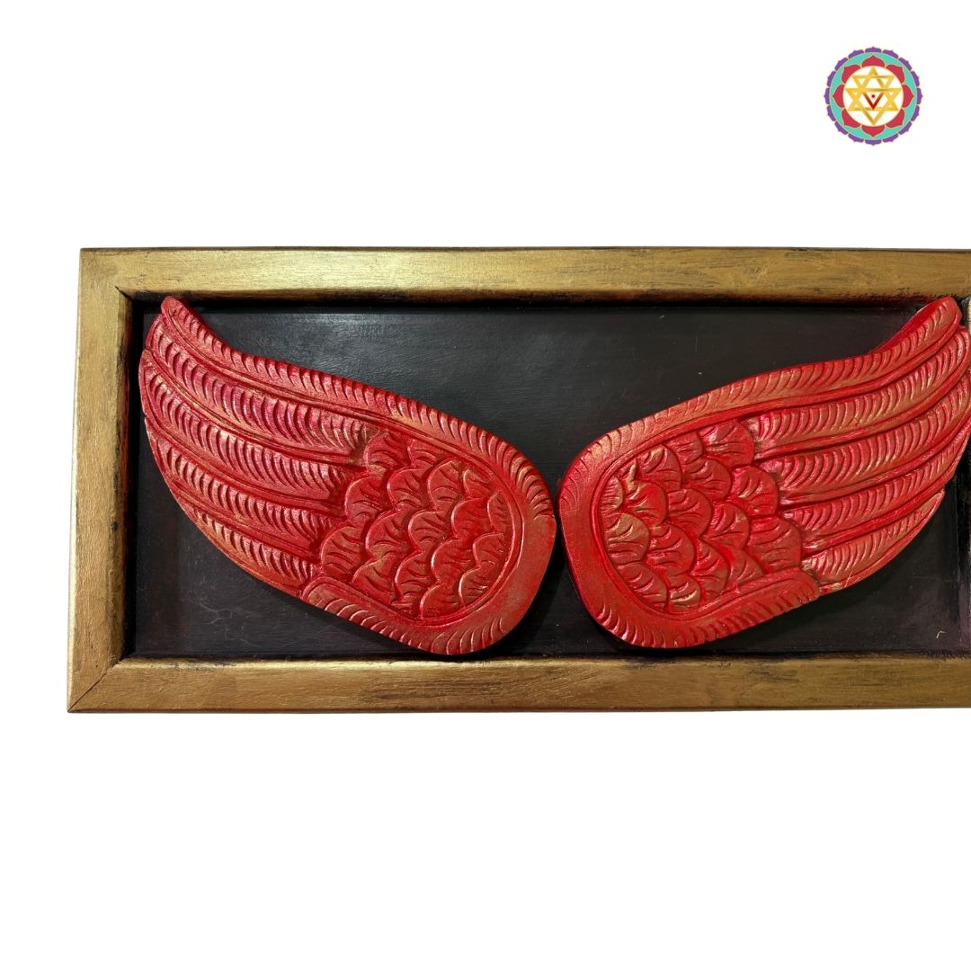 Side-angle display of carved wooden angel wings frame