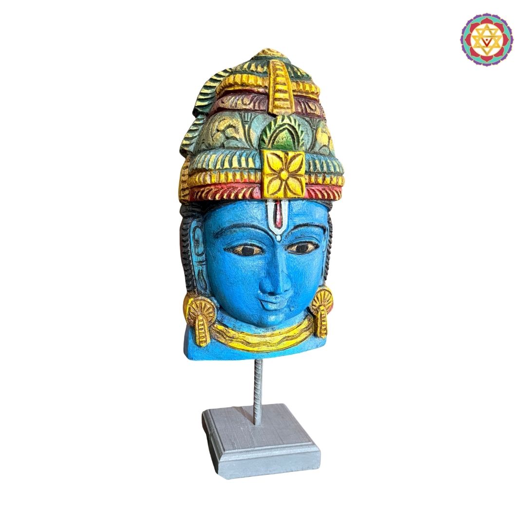 Close view of Vishnu mask with traditional carved patterns
