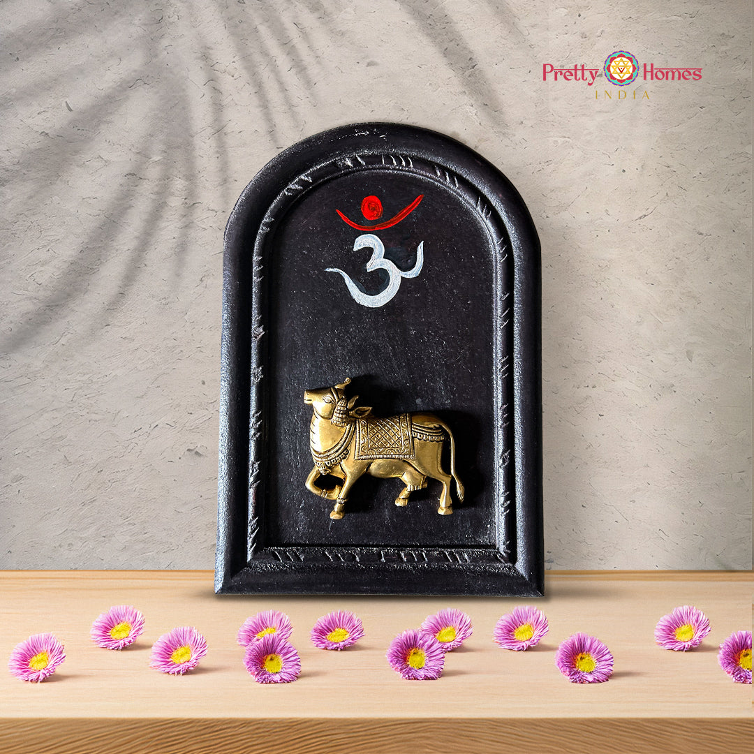 Unique shape carved frame with brass cow and Om painting.