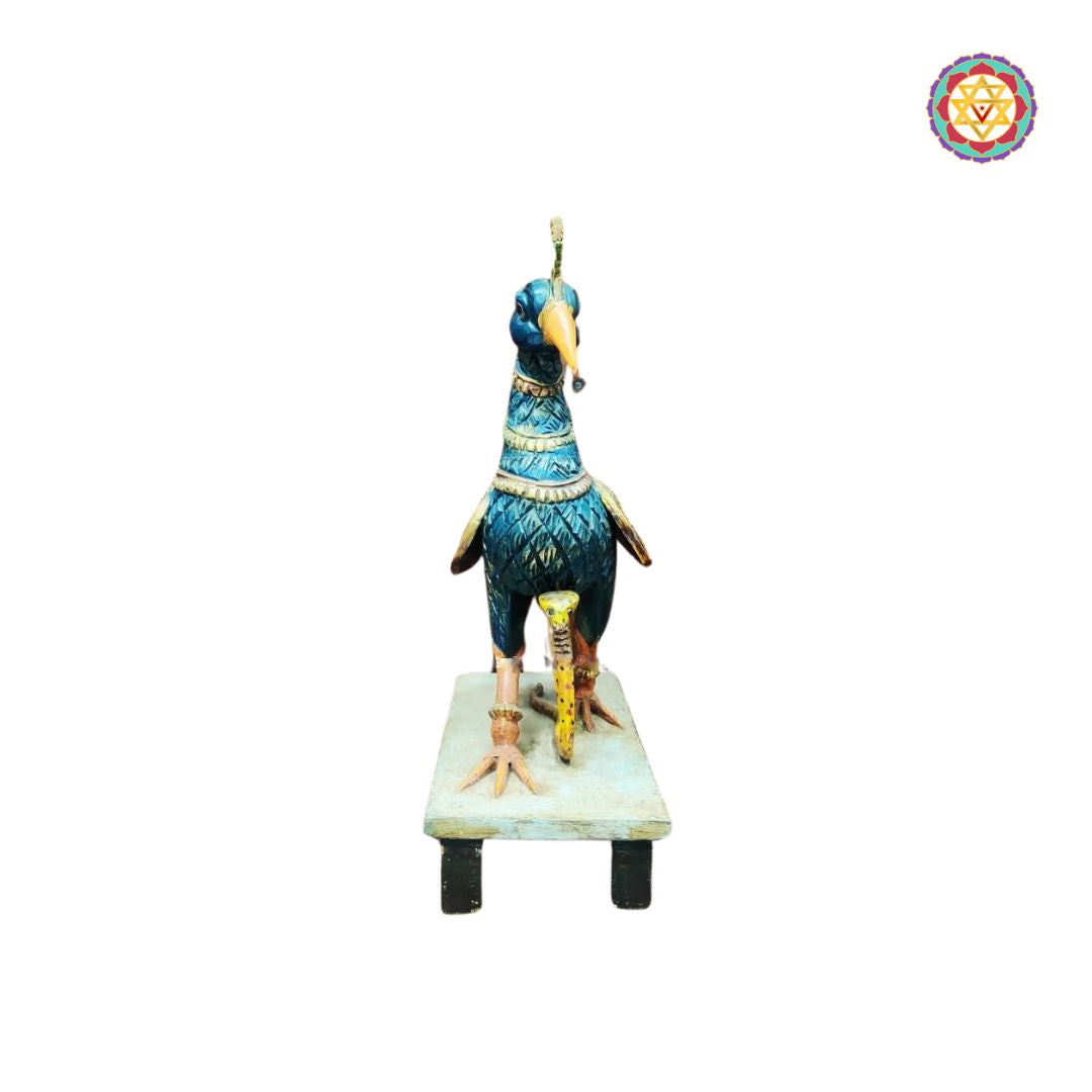 rear view of wooden peacock sculpture with detailed carving