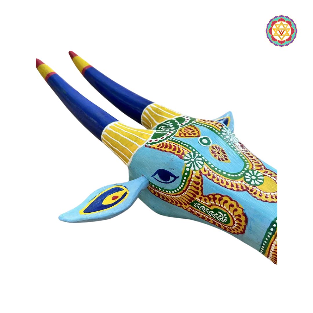frontal shot of cow head decor featuring artistic blend of blue and yellow tones
