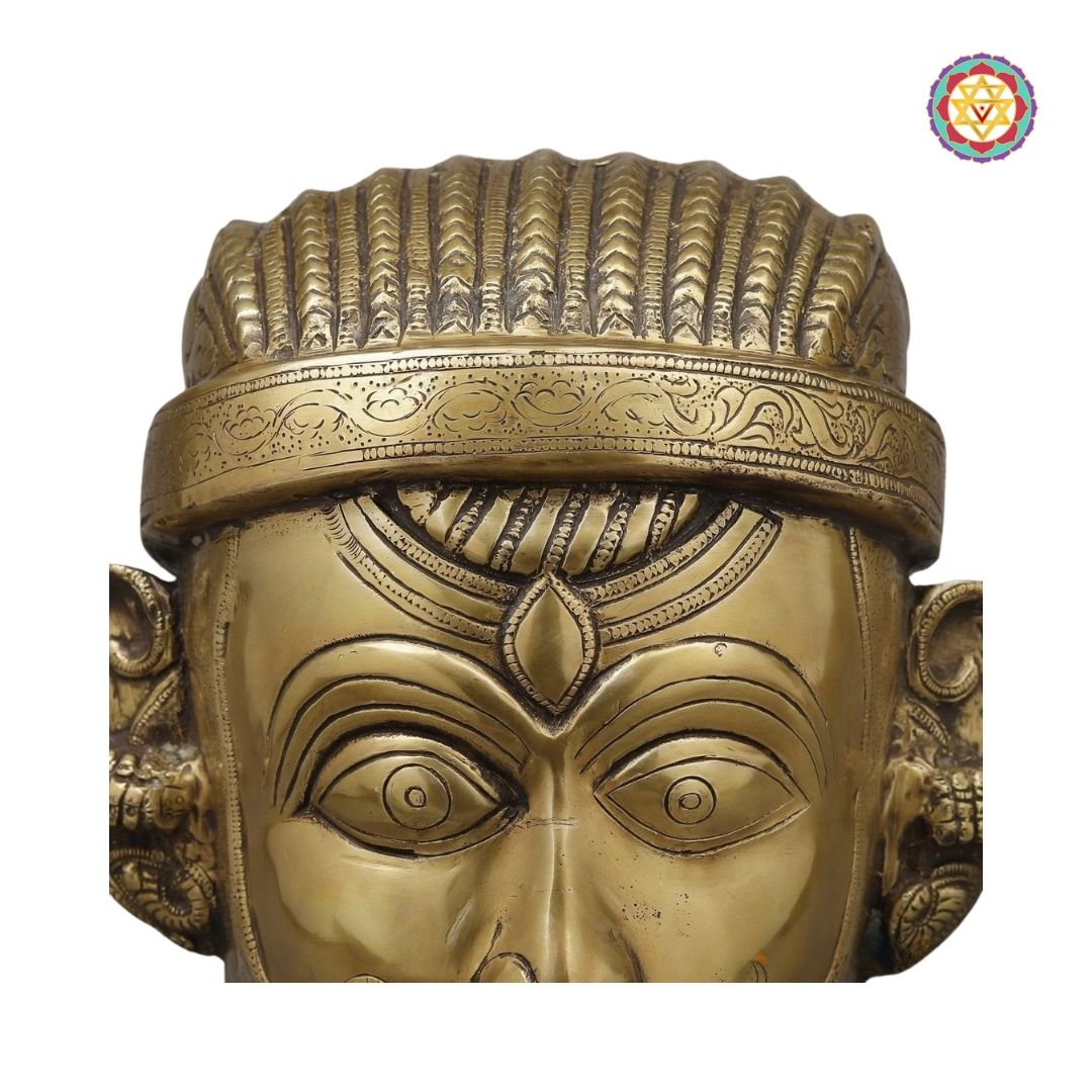 angled shot of Shiva face idol emphasizing smooth golden texture