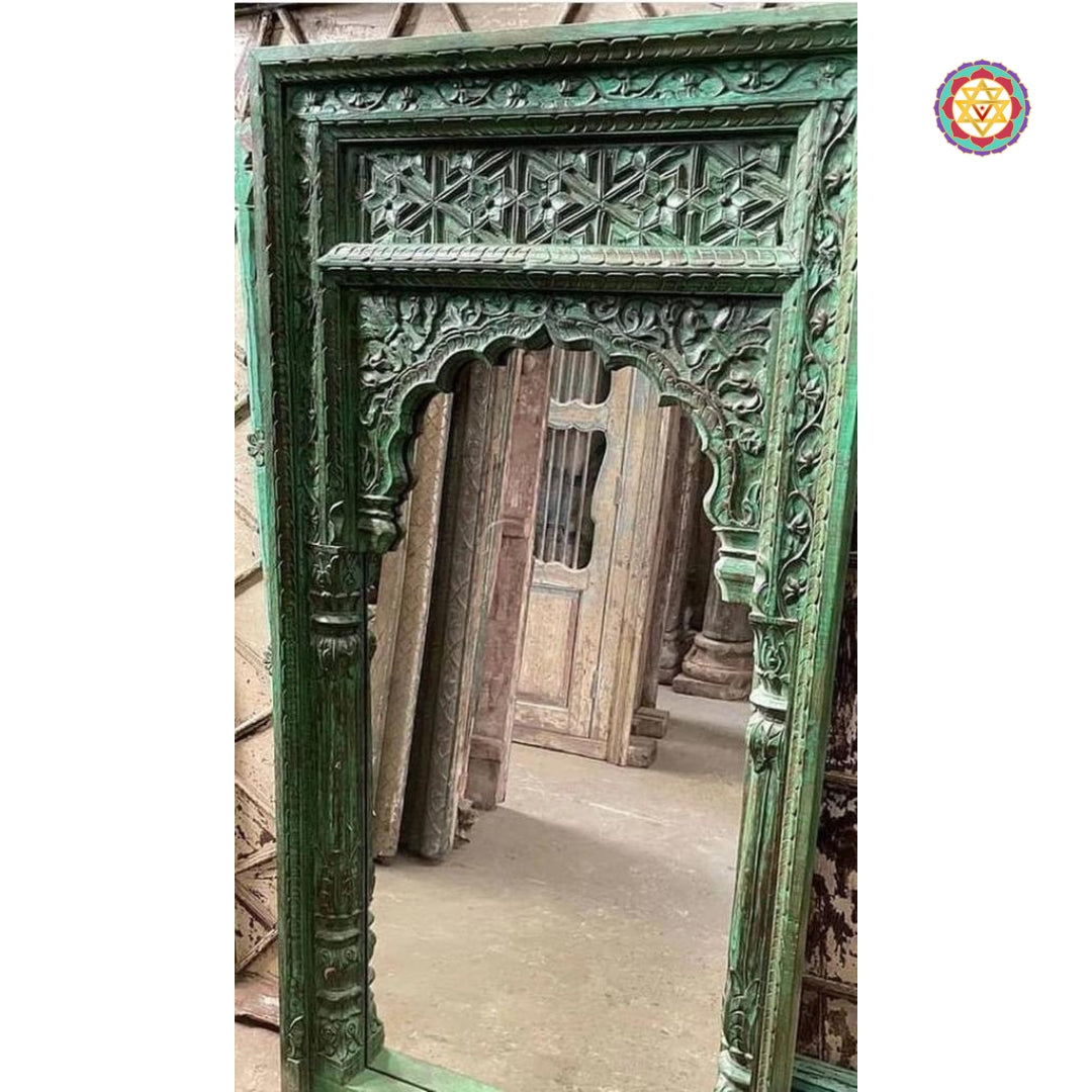 “Close-up of the intricate wooden latticework and floral patterns on the Jharokha mirror.”