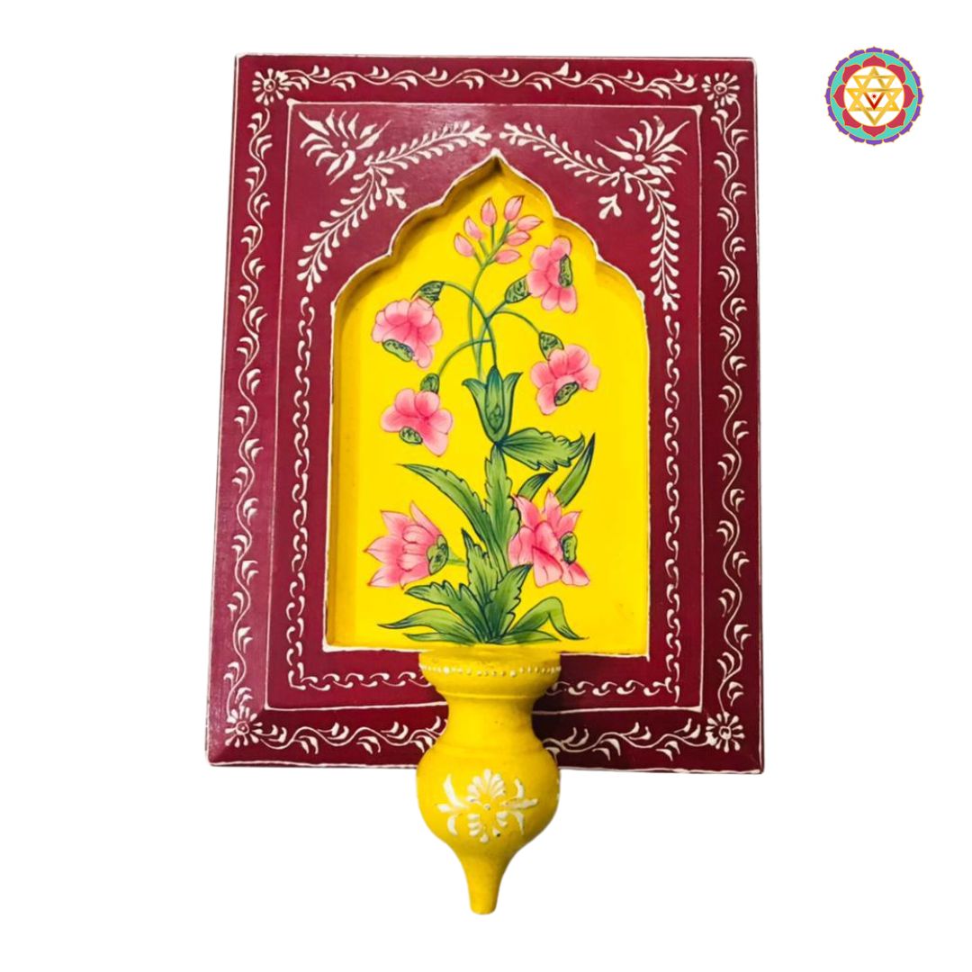 Close-up of yellow frame with pink floral motifs