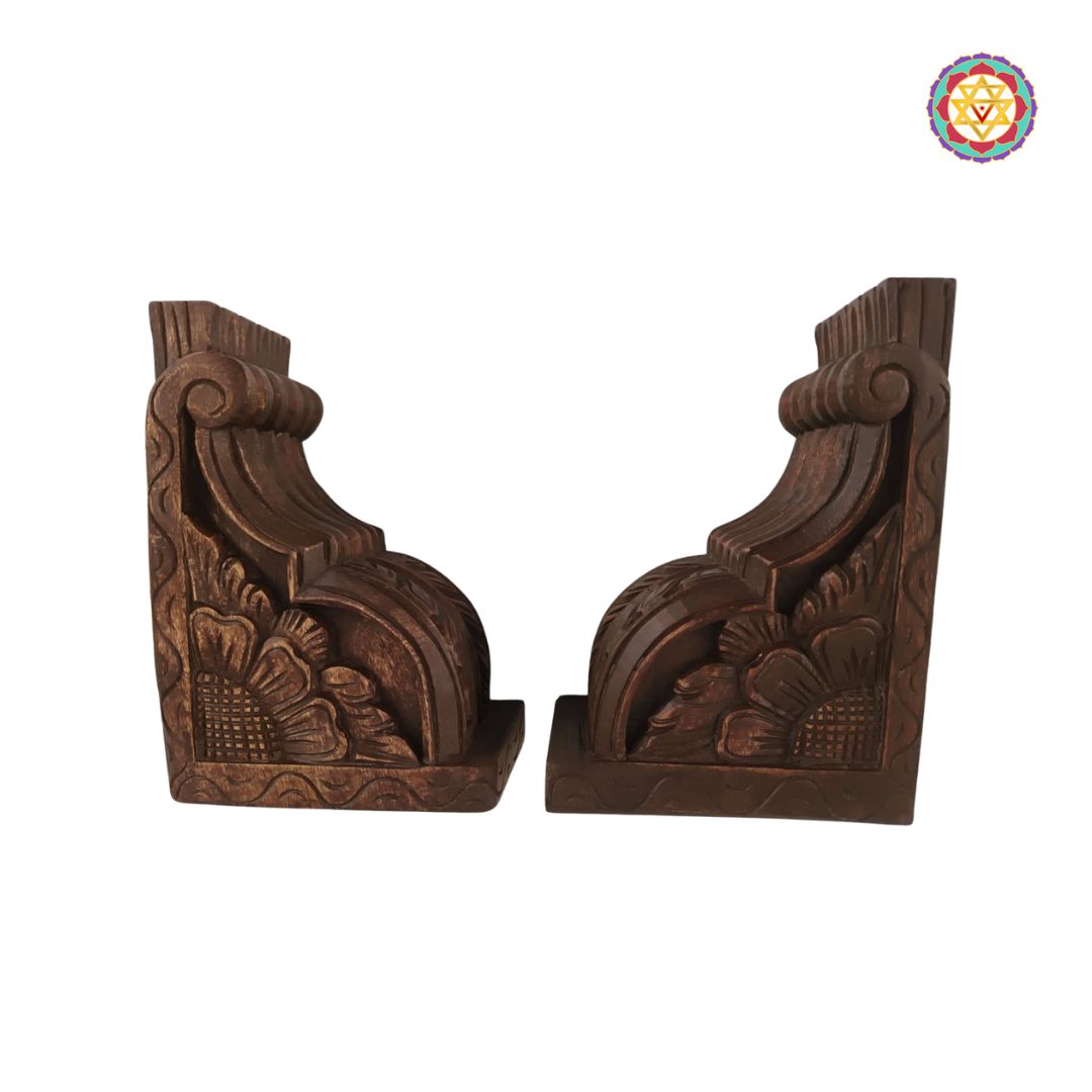 Pair of wooden corbels with intricate carvings on a white background