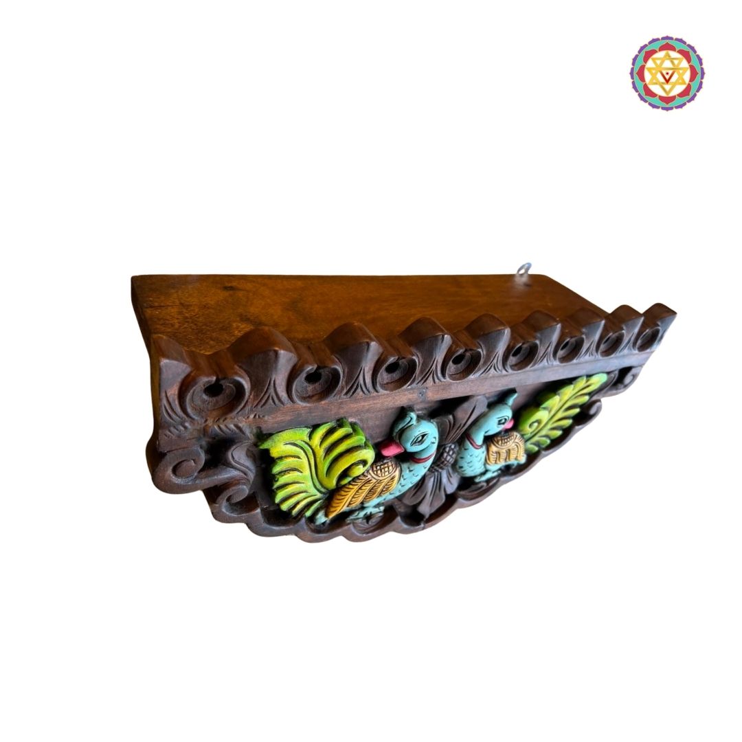 Close-up of annam carvings on mahogany wall shelf with antique polish finish