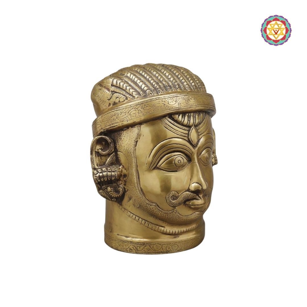 side-angle view of golden Shiva face highlighting traditional features