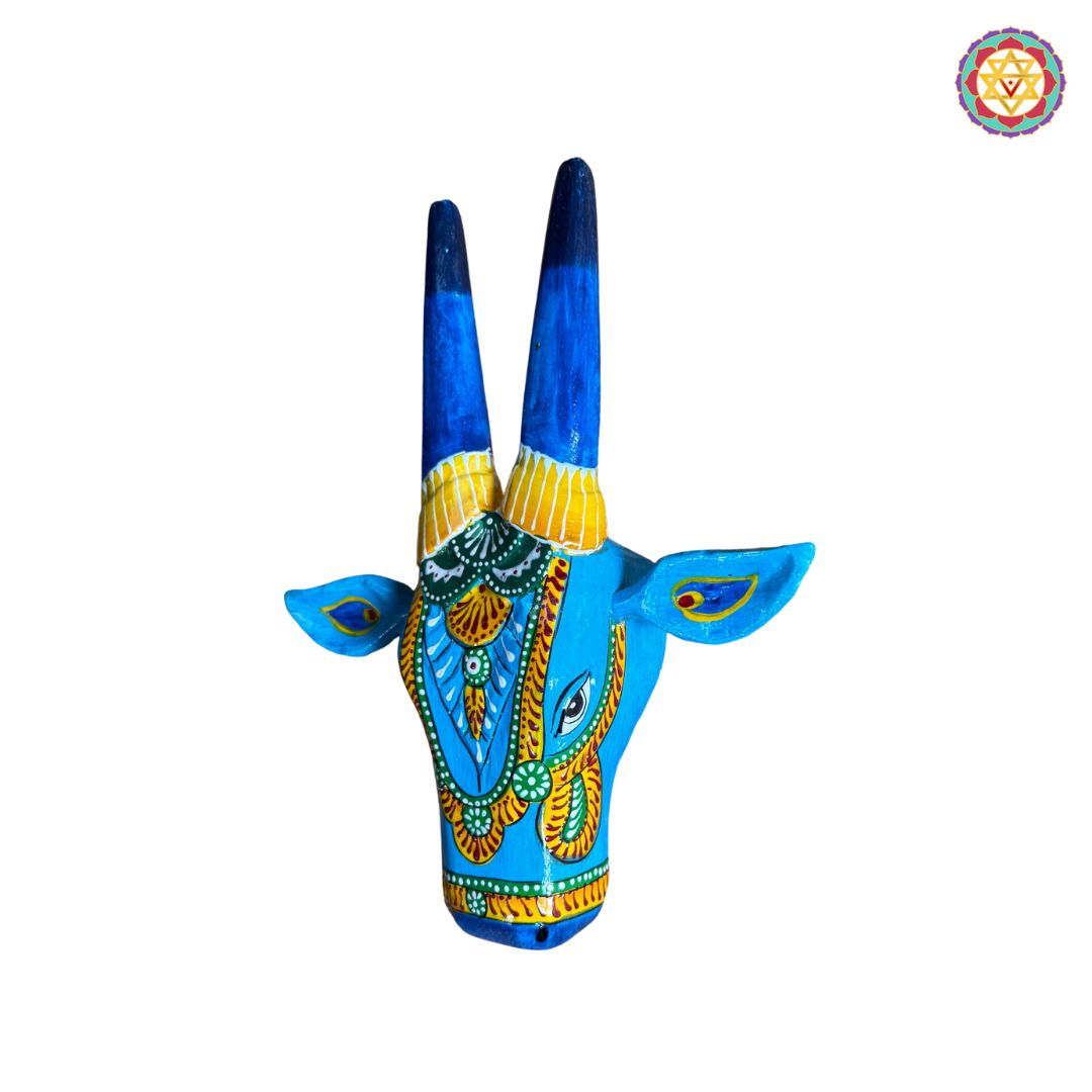 Texture and carving detail of blue Nandi cow head wall art
