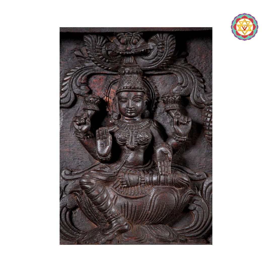 Detailed Lakshmi carving on wood wall panel

