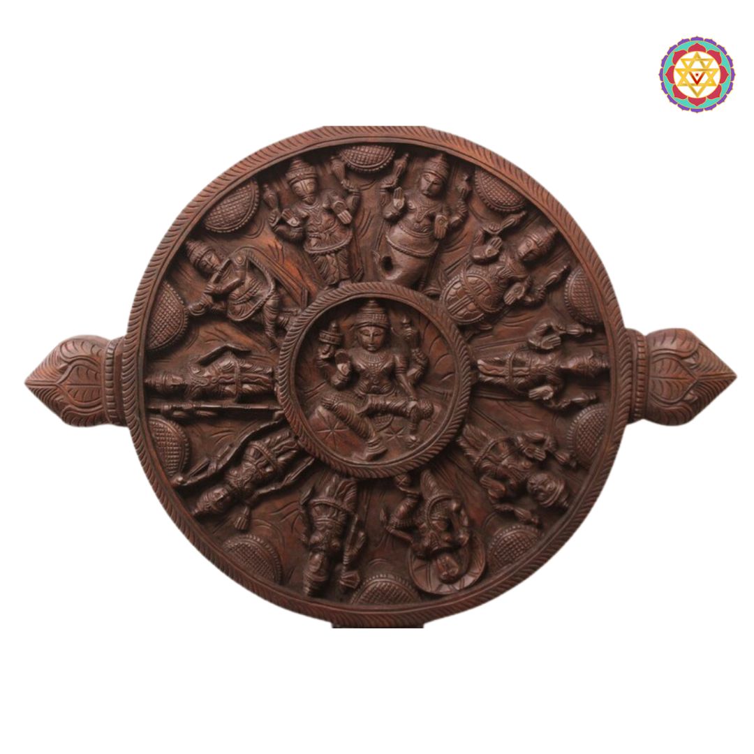 Wooden relief sculpture with intricate carvings on a white background. Close-up of Ashtalakshmi center on round Dasavatara wood panel.