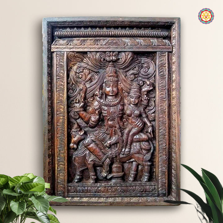 Vertical wooden panel of Shiva and Parvati seated on Nandi in traditional carving