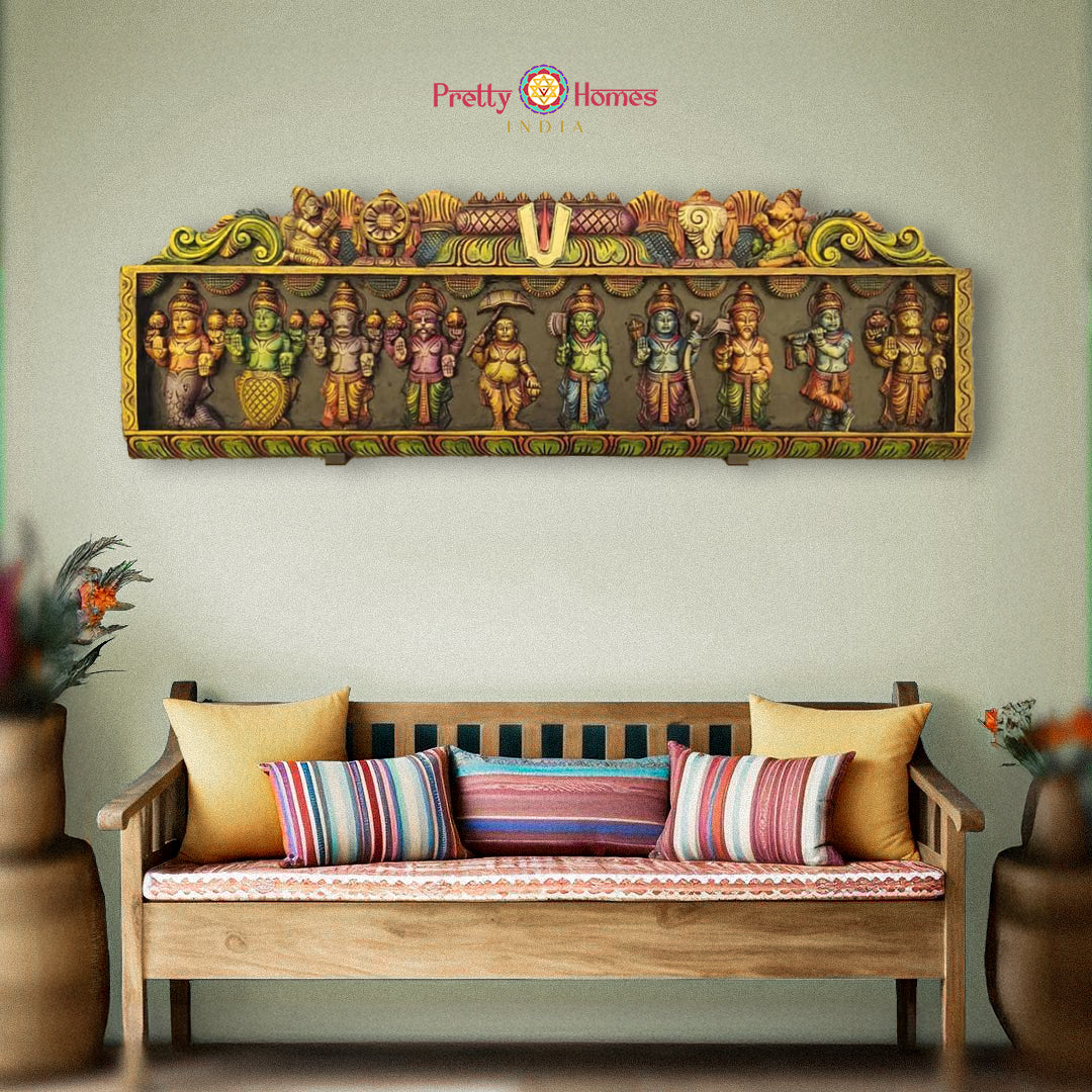 A wall-mounted wood carved panel depicting the ten primary incarnations or Avatars of Vishnu, with Vishnu symbols and Garuda and Hanuman on either sides, displayed above a bench with pillows.