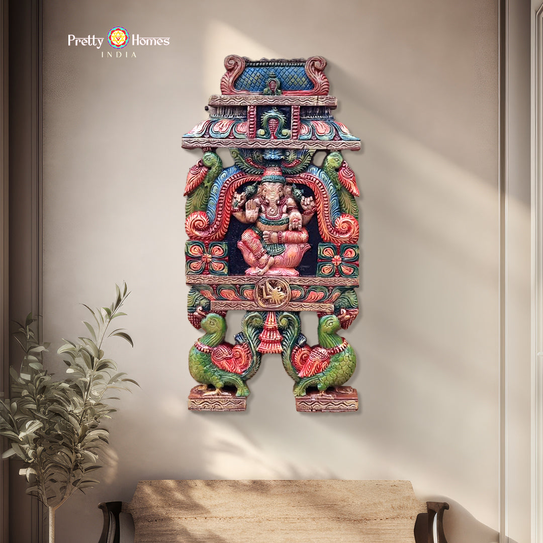 A woodcarved Ganesha Kavadi panel with parrots and birds in a temple Gopuram style, featuring fine carvings and multicolour finish.