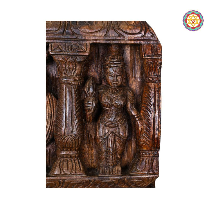 Wooden carvings of a figure and architectural elements on a white background. Close-up of carved Murugan kavadi figure

