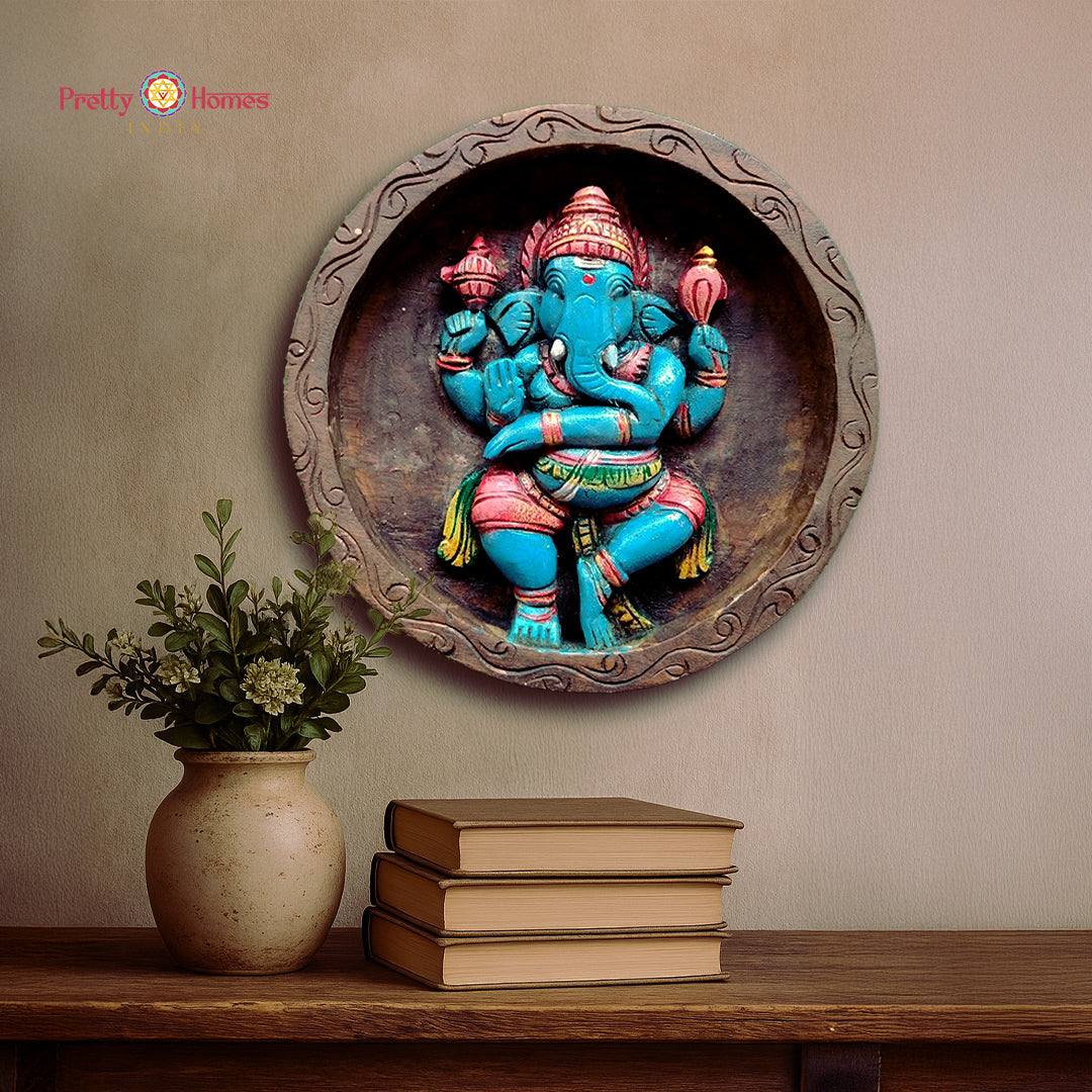 dancing ganesha round wood carving in high-relief, joyful posture and engraved floral frame