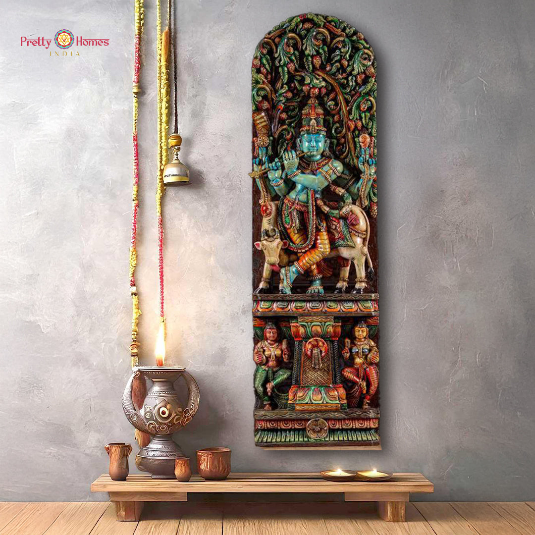 Handcarved wooden panel canopy sculpture featuring a depiction of Gopal Krishna with a cow and two gopis, with a vibrant multicolored finish.