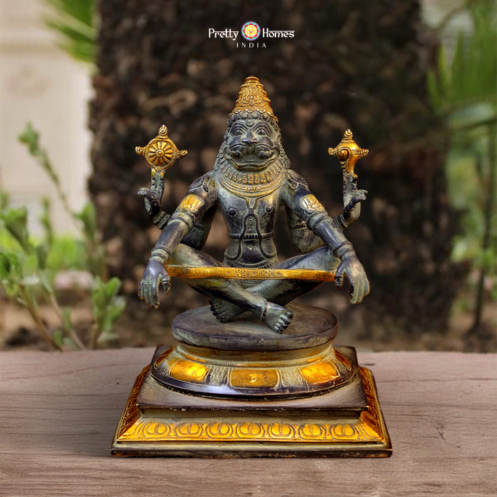 brass Yog Narasimha idol with black patina and golden accents