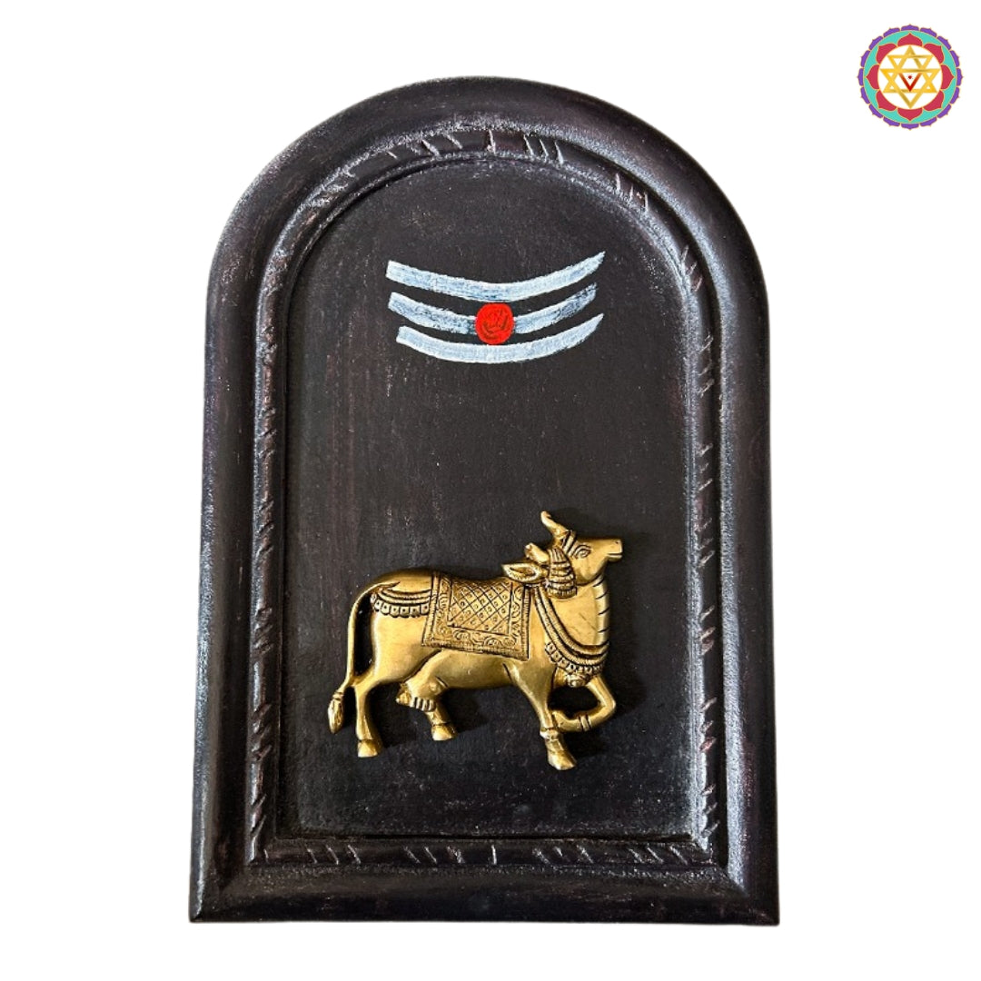 Traditional wooden frame with Vishnu chakra and conch brass carving