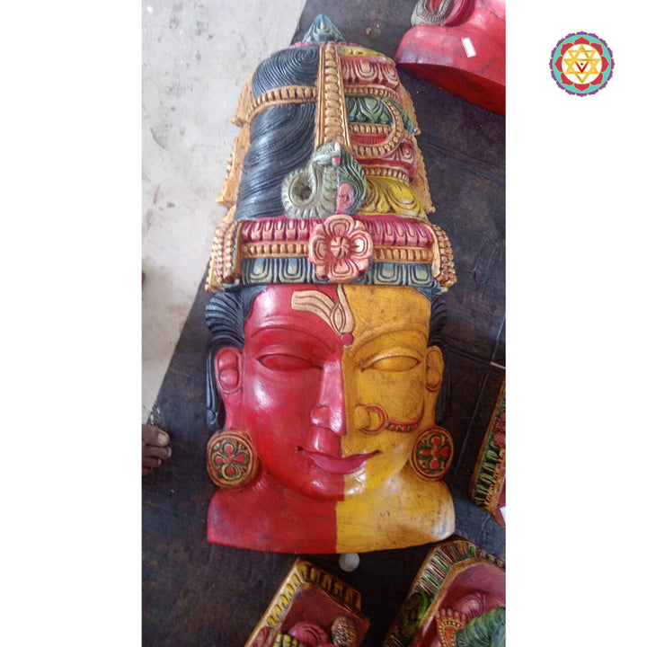 Close-up of half Shiva, half Parvati wooden mask wall hanging
