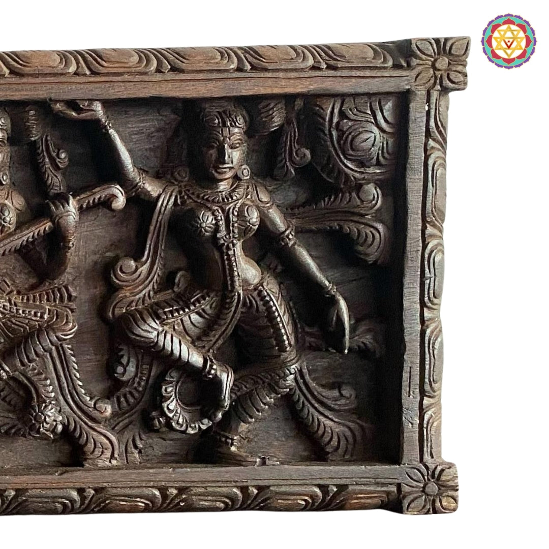 Carved horizontal wooden panel with celestial dancers
