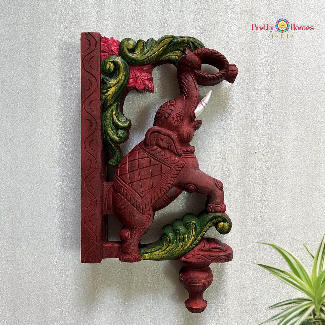 Hand-carved trunk-up elephant wooden brackets with floral vines