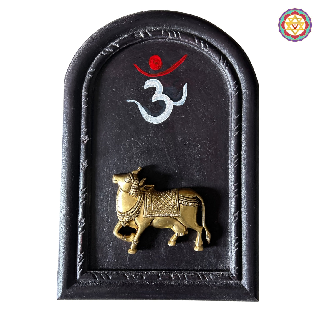 Handcrafted brass Om with cow and calf — wooden framed wall art.
