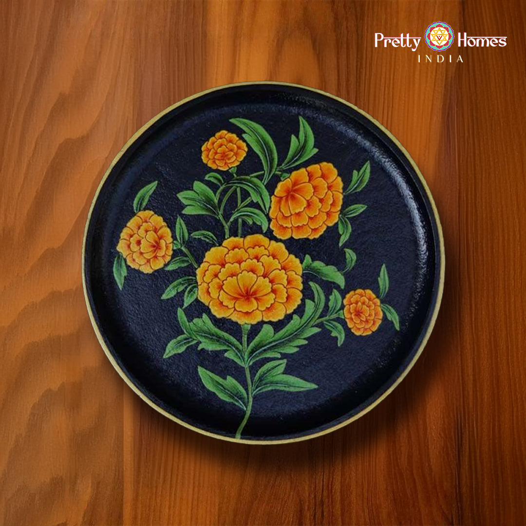 Hand-painted round plate with orange marigold flowers on deep black background