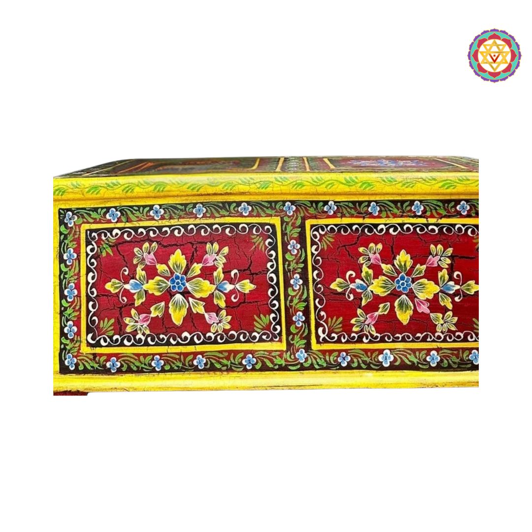 side angle of floral hand-painted wooden trunk table