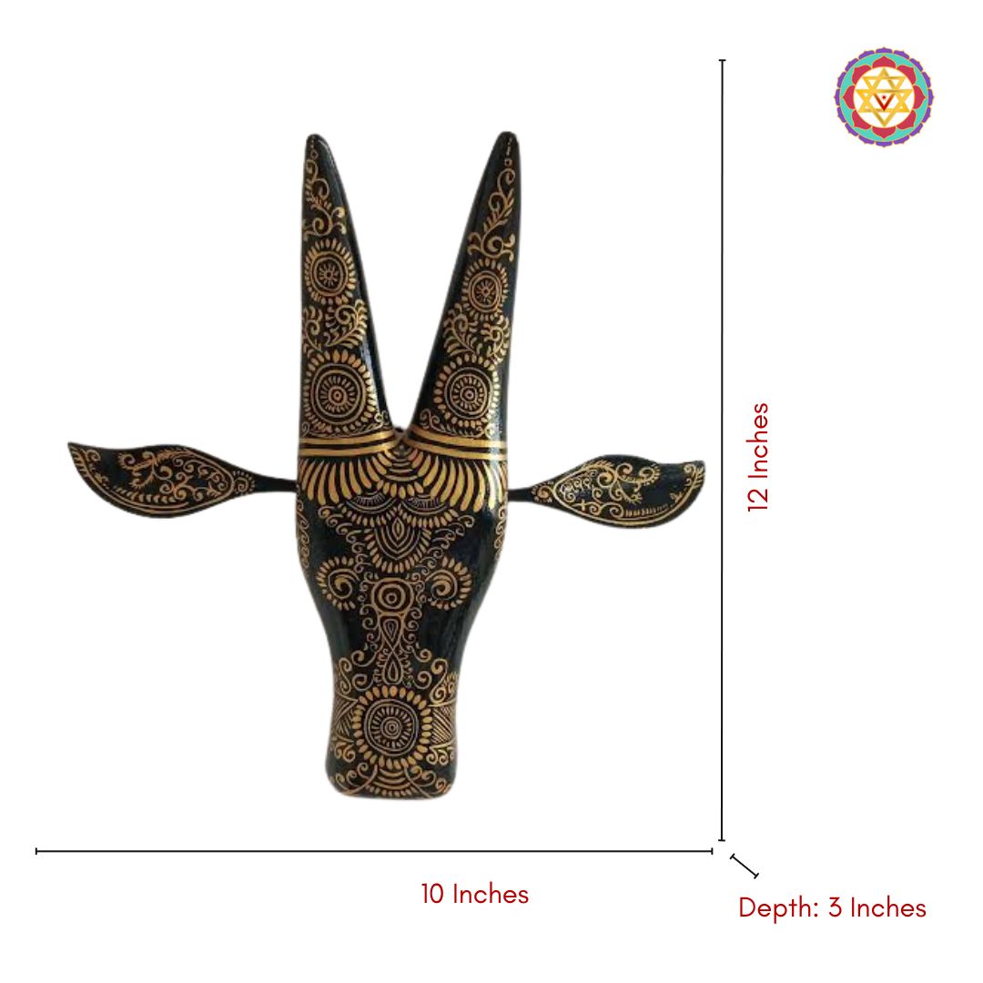 close-up of black nandi head carving showing minimalist painted motifs and carved grain