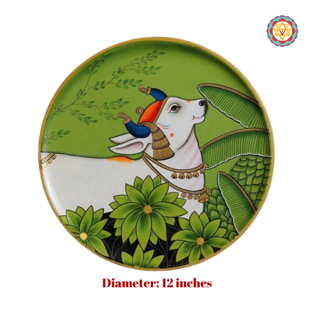 Hand painted wall plate featuring cow and forest, pichwai design