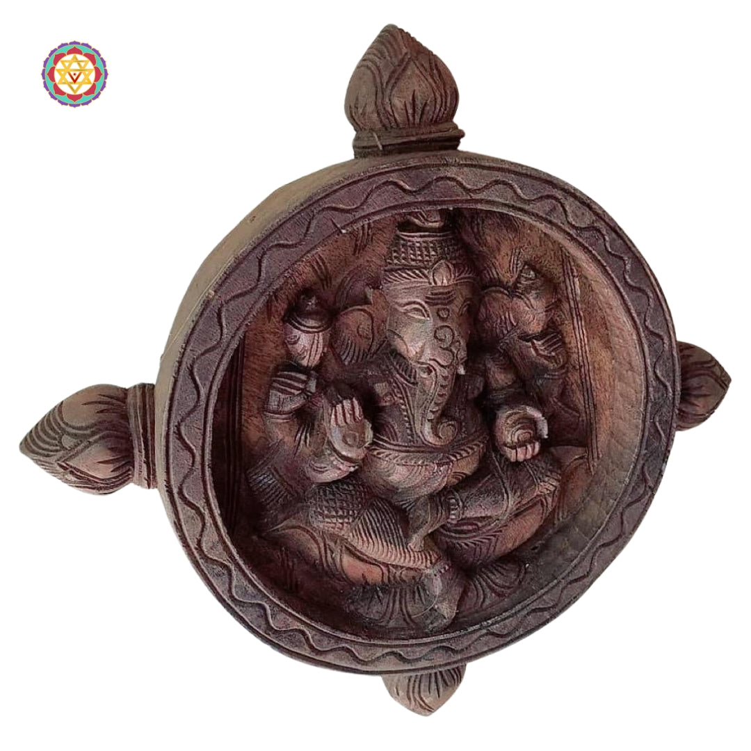 Carved wooden wall art of Ganesha with intricate motifs