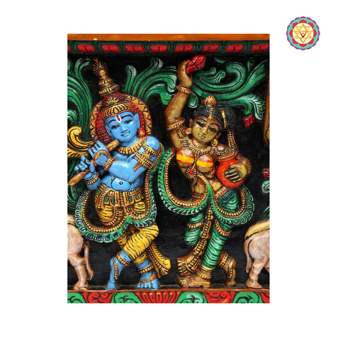 Decorative panel with two deities in colorful attire on a black background - Close-up of Venugopal Krishna carving holding flute