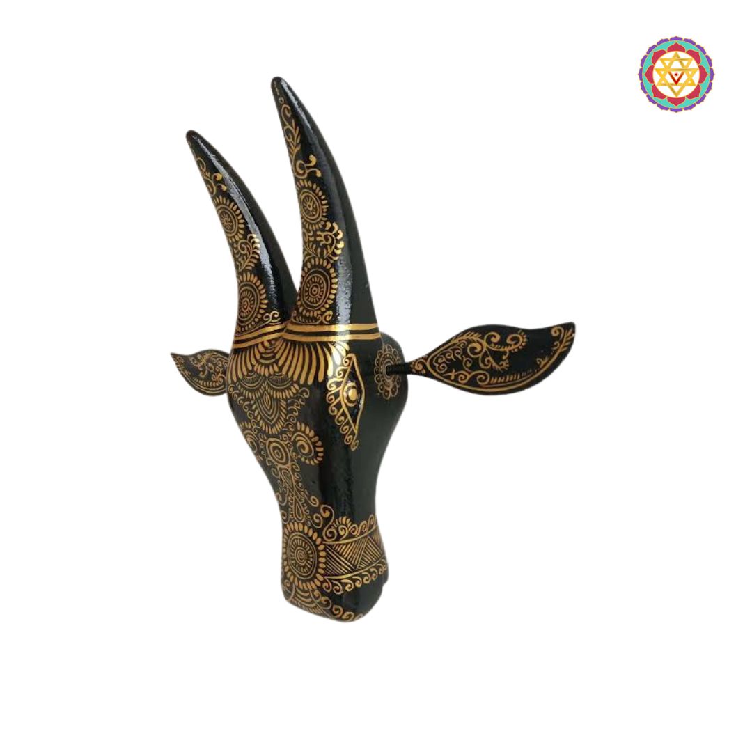 angled lifestyle shot of black cow head wall decor over textured wall background