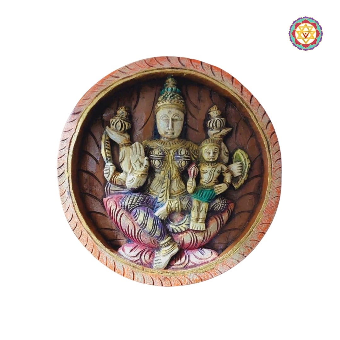 Santana Lakshmi carved wooden panel holding child and lotuses, seated in traditional attire