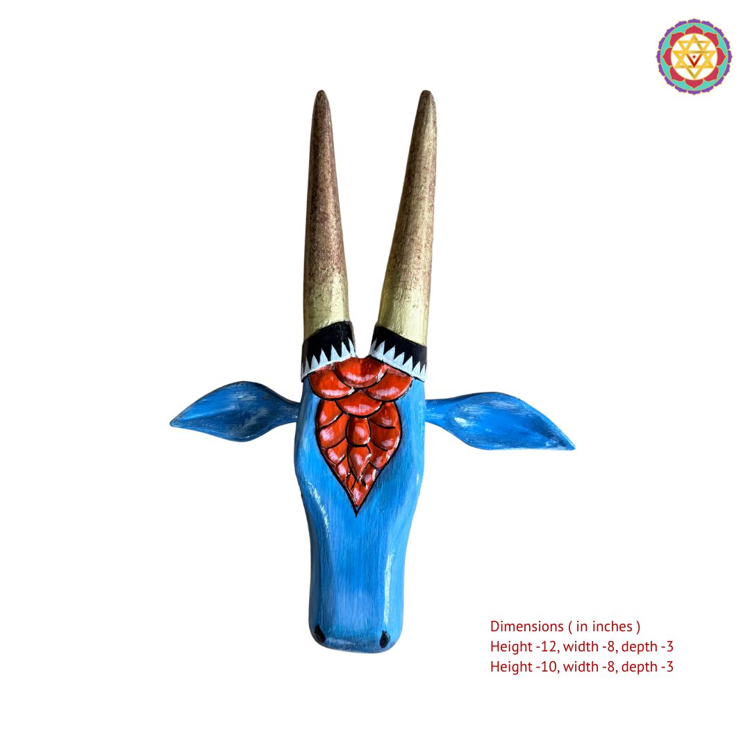 Side angle view of red and blue handpainted Nandi cow head wall art