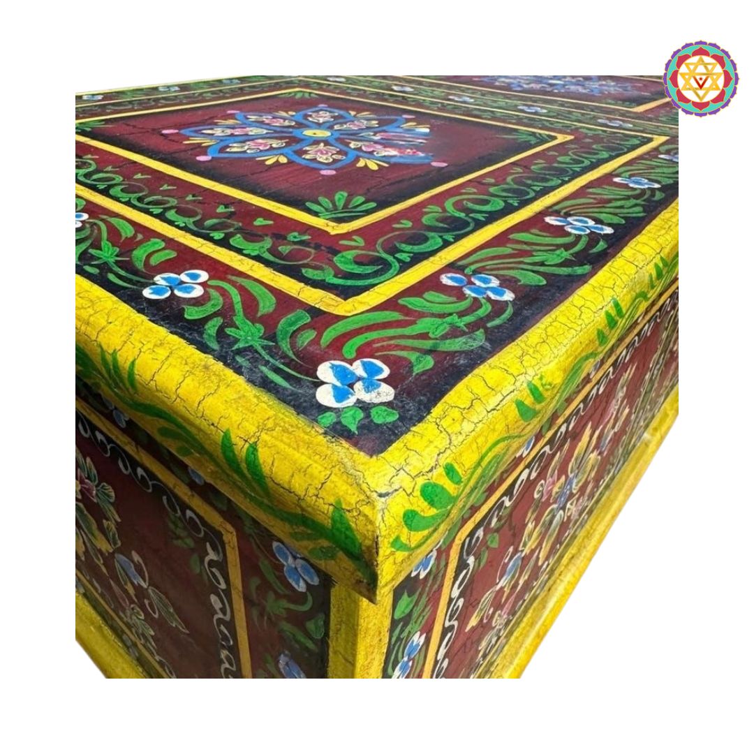 close-up of floral artwork on hand-painted wooden storage trunk