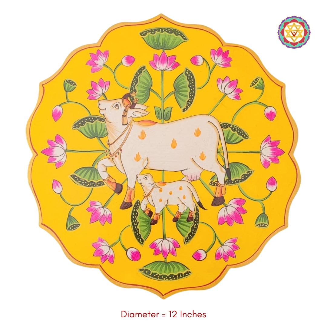 Studio shot of petal-shaped pichwai cow with calf wall plate. Handcrafted 12-inch wooden piece for pichwai home decor.