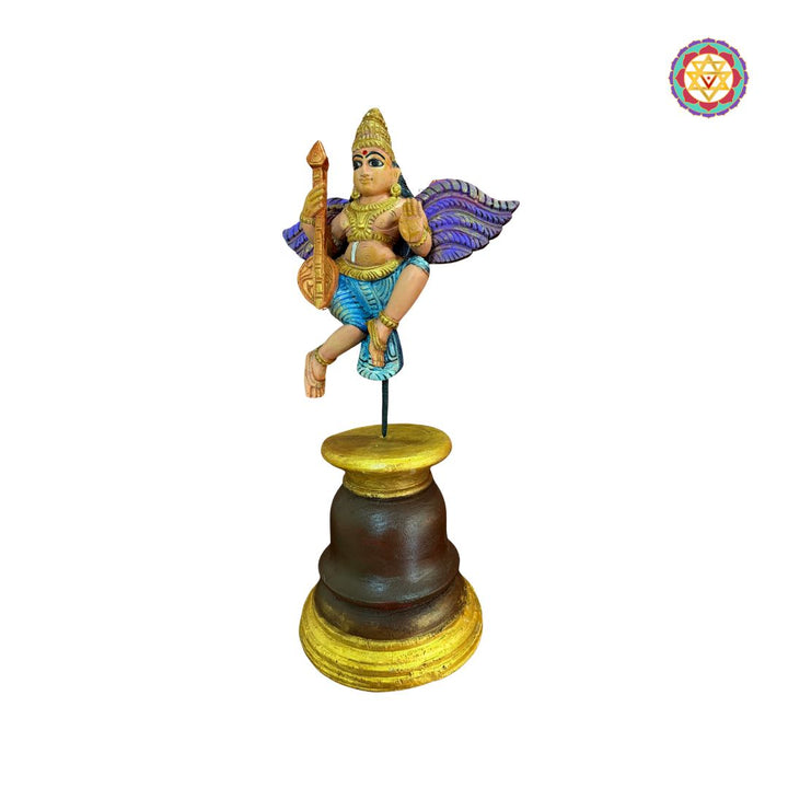 Beautifully handcarved Gandharva (Indian Angel) playing the Veena, crafted on a sturdy wooden stand.