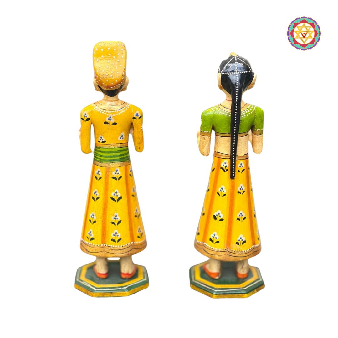 set of handcrafted isar gangaur wooden dolls on display shelf