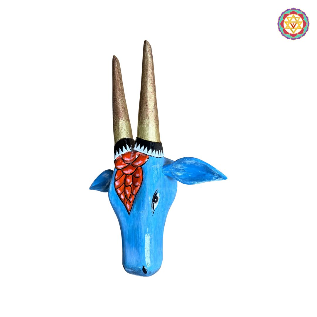 Closeup of carved and painted details on red blue Nandi wall art