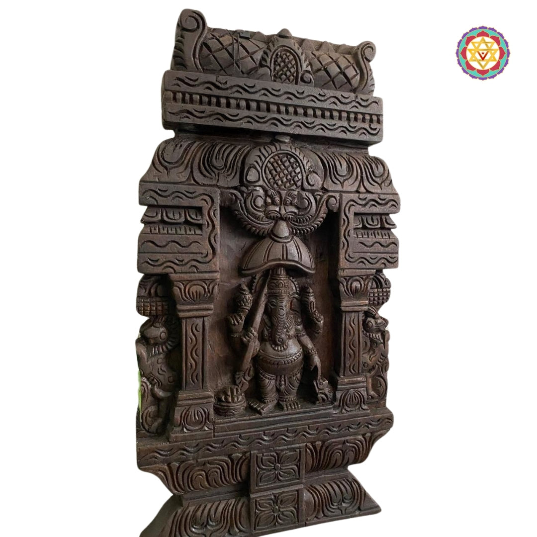 Side view of umbrella Ganesha wall hanging in temple frame
