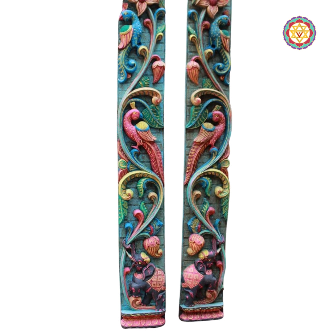Close-up of hand-painted parrot and elephant carvings on Vagai wood