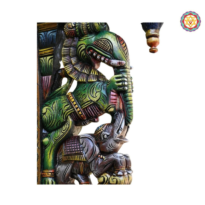Side view of multicolour wooden corbel featuring elephant carving